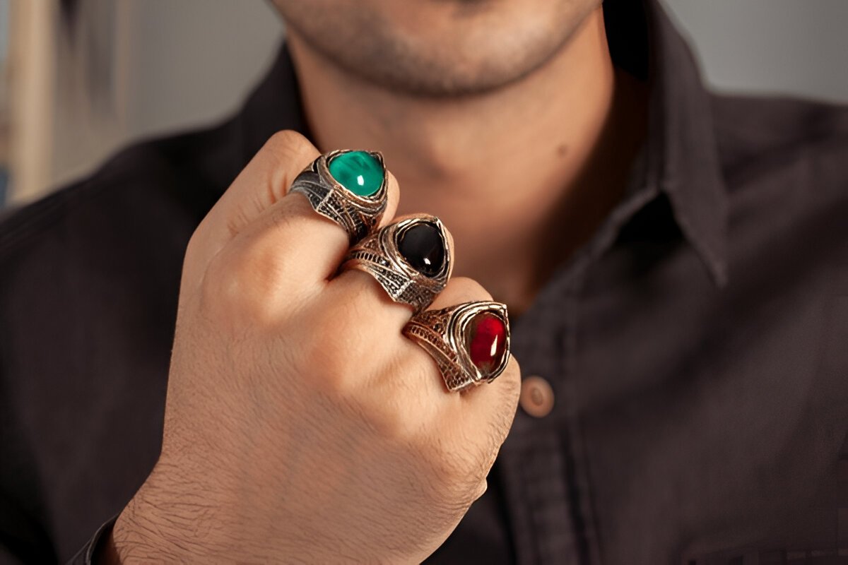 Charismatic man showing silver ring.