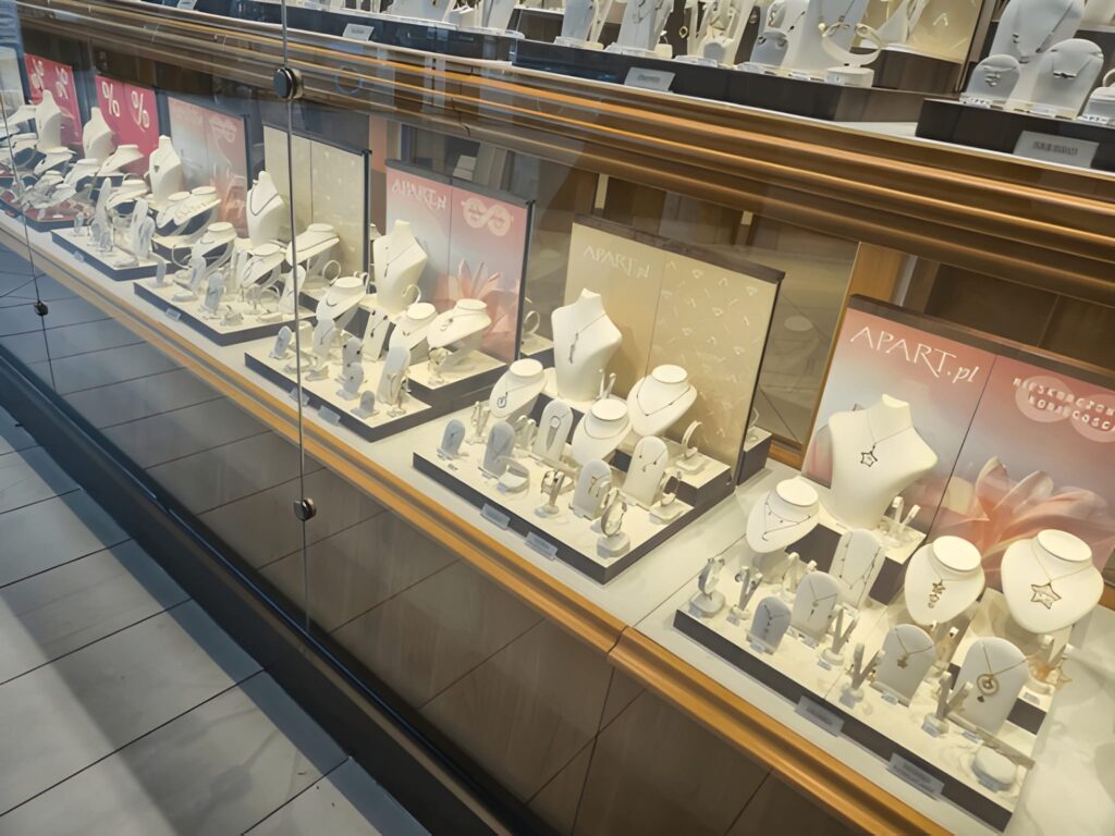Przemysl, Poland - March 1, 2025 Display of elegant jewelry in a retail store window, showcasing necklaces, earrings, and bracelets arranged neatly, attracting potential buyers.