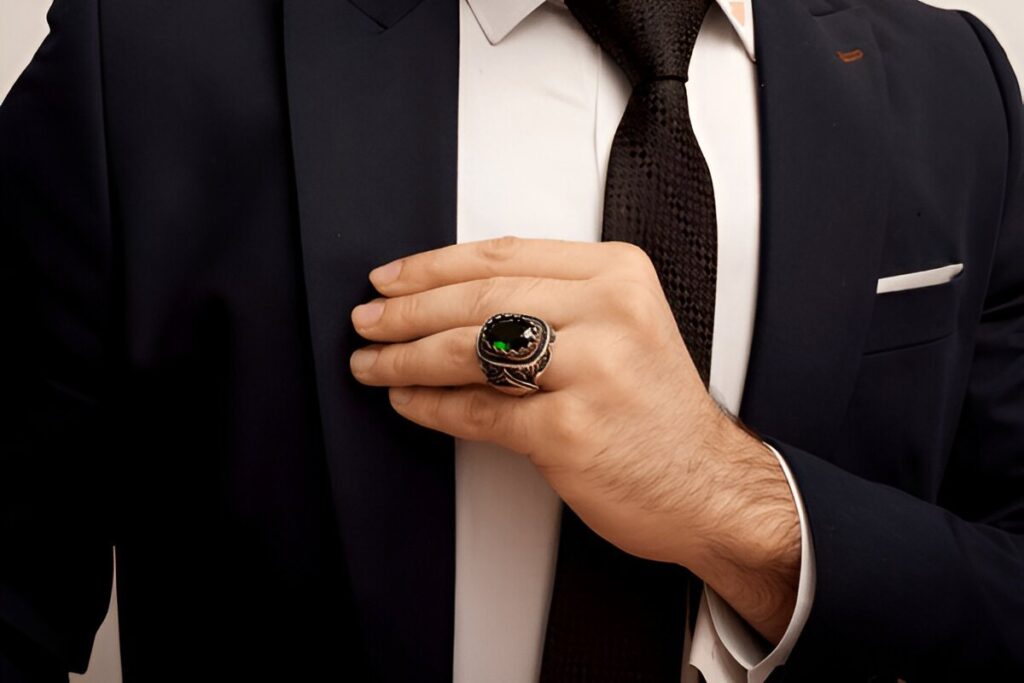 Business person wearing a emerald gemstone ring